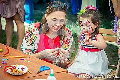 Mother and daughter participating at art and craft outdoor workshop Editorial Stock Photo